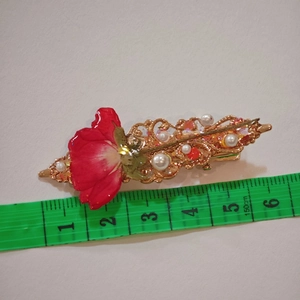 Macro shot showing dimensions of handmade floral duckbill clip with pearls and dried rose