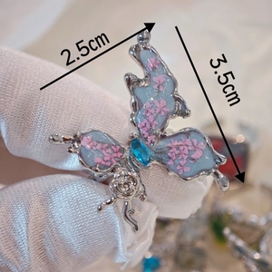 Handmade Chinese style butterfly ring with blue dried flowers and silver finish