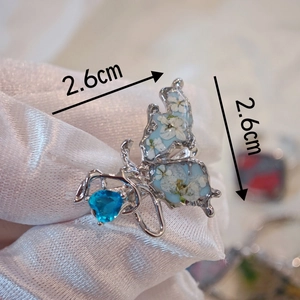 Handmade butterfly ring with real dried flowers and blue gemstone in silver metal