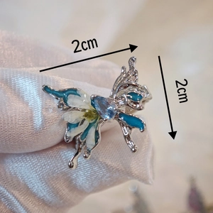 Handmade butterfly ring with real dried flowers and blue gemstone in a natural vintage style