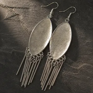 Detailed close-up of ethnic style antique silver tassel earrings with a miao silver finish