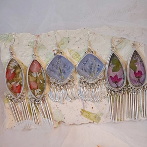 Ethnic style silver earrings set with real dried flowers and fringe tassel detail