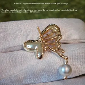 Detail view of butterfly earring with pearl and 14k gold plated silver needle measurements