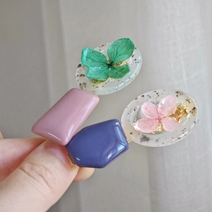 Handmade resin hair clip featuring real dried flowers, gold leaf flakes and pastel resin blocks
