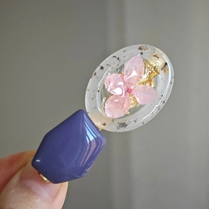 Handmade resin hair clip with purple geometric elements, pink dried flowers and gold foil