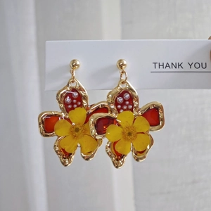 Handmade vintage gold flower earrings featuring real yellow dried flowers and red resin detail