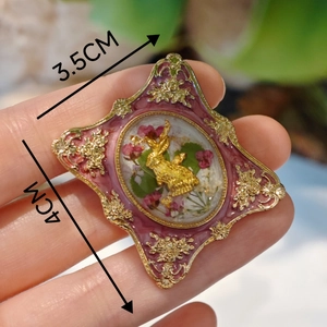 Detailed view of vintage French brooch featuring gold rabbit and dried flowers in resin
