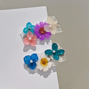 Handmade hair clips featuring lace flowers, real pearls and dried flowers in soft colors