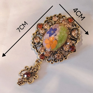 Luxurious vintage palace style brooch with dried flowers, rhinestones and teardrop pendant