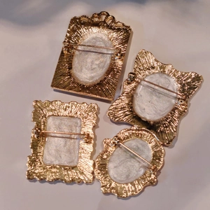 French vintage enamel flower brooches with gold frames and textured metal back details