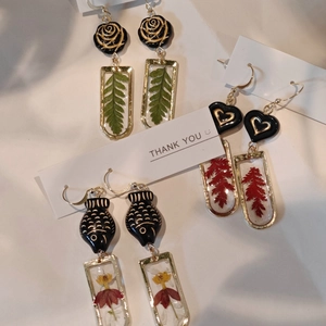 Handmade botanical resin earrings with dried flowers and leaves in gold rectangle frames