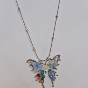 Handmade butterfly pendant necklace with blue dried flowers and pearl accents