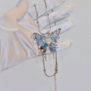 Handmade butterfly necklace with blue real flowers and colorful beads on silver chain