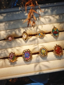 Detail view of 8-piece vintage ring set featuring real dried flowers in gold alloy settings