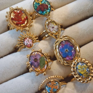 Handmade gold stainless steel ring set with dried flowers in resin and vintage carvings