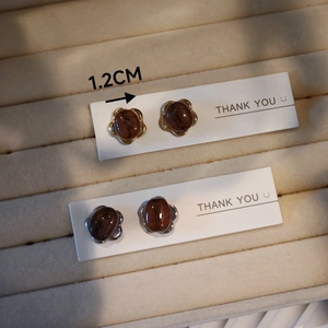 Detailed view of handmade coffee bean stud earrings with 1.2cm diameter measurement