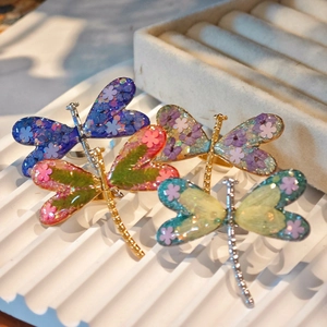 Handcrafted dragonfly open rings with colorful dried flowers and resin wings on metal bands