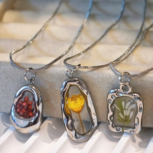 Handmade stainless steel necklace with real dried flower specimens in resin pendants
