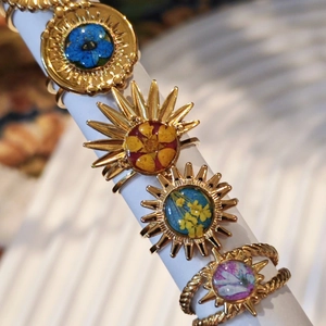 Handmade stainless steel sun goddess rings featuring real dried flowers in resin