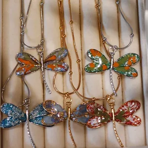 Handmade dragonfly necklaces with real dried flowers in resin, set in velvet jewelry box