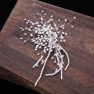 Luxurious bridal hair accessory with silver rhinestones and pearls on dark wood