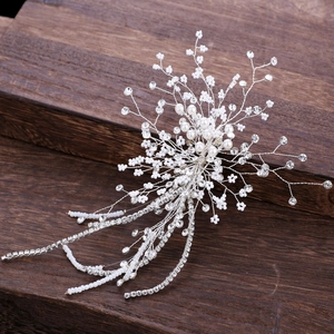 Luxurious bridal hair headpiece with pearls and rhinestones on a rustic wood background
