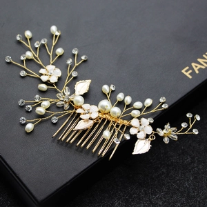 Detailed view of handmade bridal hair comb with enamel flowers, pearls, and crystals