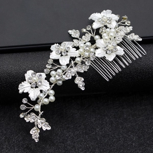 Silver flower bridal hair comb with pearls and rhinestones on black background