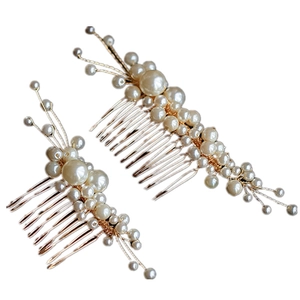 Detail of handmade pearl bridal hair combs with gold wire and ivory beads for wedding styling