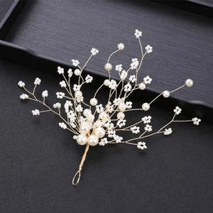 Close-up of handmade bridal hairpiece with gold wire branches and white pearls