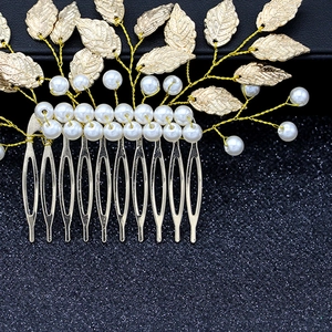 Detail of handmade gold baroque leaf hair comb with white pearls and metal alloy wiring