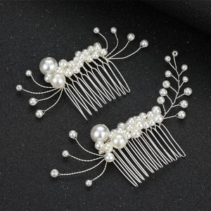 Detailed macro view of handmade bridal hair combs with white pearls and silver wire