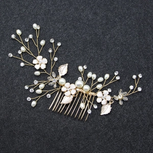Golden bridal hair comb with white flowers, pearls and crystal leaves on black base