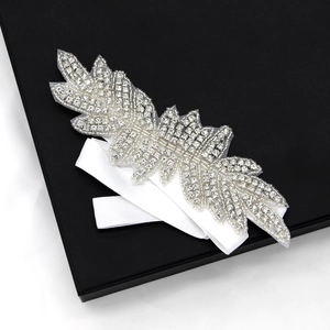 Luxury bridal headband with silver rhinestone feathers and white silk ribbon trim