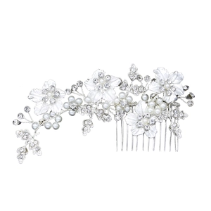 Detailed view of silver bridal hair comb with metallic flowers, crystals and white pearls