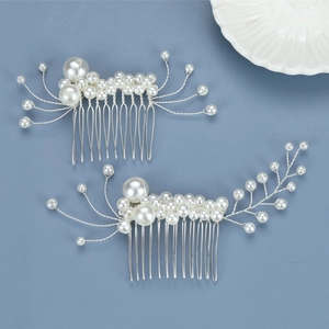 Detail of two handmade bridal hair combs with white pearls and silver wire weaving