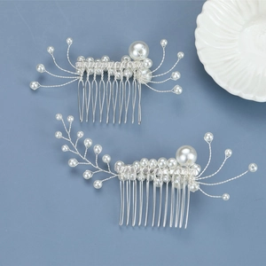Detailed close-up of handmade bridal hair combs with white pearls and silver wire accents
