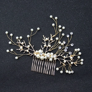Elegant bridal hair comb with pearls and rhinestones on gold branches for weddings