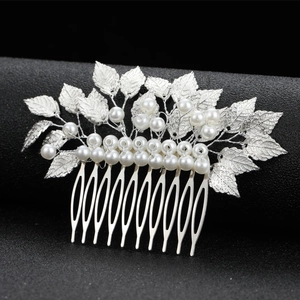 Macro detail of silver baroque leaf wedding hair comb with cluster pearls and metal texture
