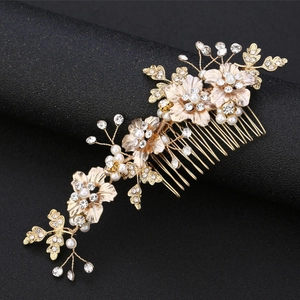 Detail showing golden flower hair comb with white pearls and sparkling rhinestones