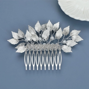 Close-up of silver baroque leaf bridal hair comb with elegant white pearls and ten teeth