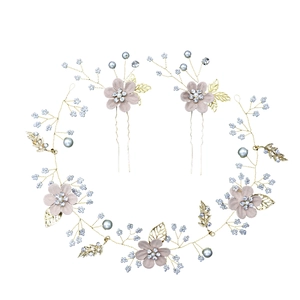 Detail of bridal floral hair vine set with pink fabric flowers, pearls and rhinestones
