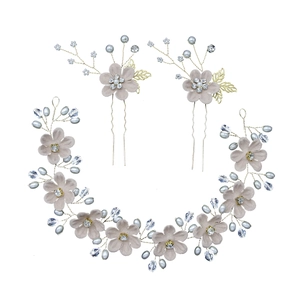 Three-piece set detail showing grey-pink flowers and blue pearls for bridal hair accessories