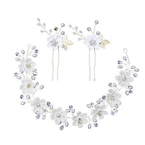 Detail of handmade bridal hair vine set with white flowers pearls and crystals