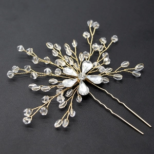 Détail de l'épingle à cheveux de mariée dorée avec perles de cristal et strass brillants