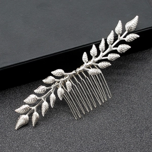 Detailed macro view of silver leaf branch hair comb with intricate vein textures