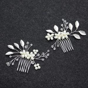Detail shot of two-piece bridal hair comb set with silver leaves and pearls