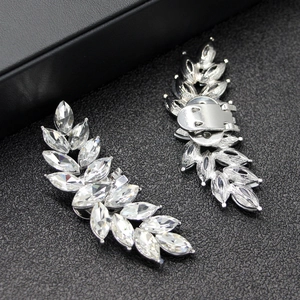 Macro shot of silver crystal leaf shoe clips with marquise-cut rhinestones for bridal shoes