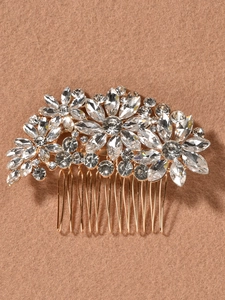 Detailed top view of a gold-plated bridal hair comb with crystal flowers and rhinestones