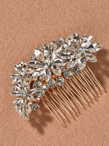 Detailed macro view of the crystal bridal hair comb with golden flower and leaf accents